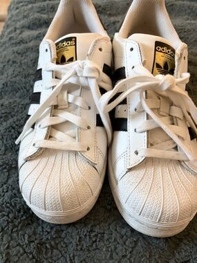 adidas White Sneakers with Black Stripes and Gold Tongue Logo